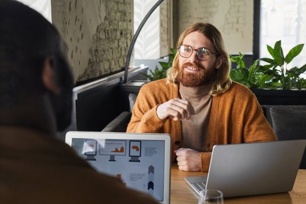 smiling-bearded-man-discussing-project-at-cafe-tab-2021-09-24-04-17-29-utc.jpg